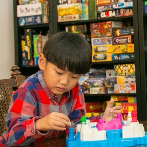 A young guest setting up pieces for a board game