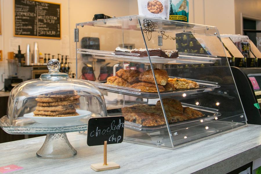 Fresh baked scones, cookies and a brownie in the bakery case